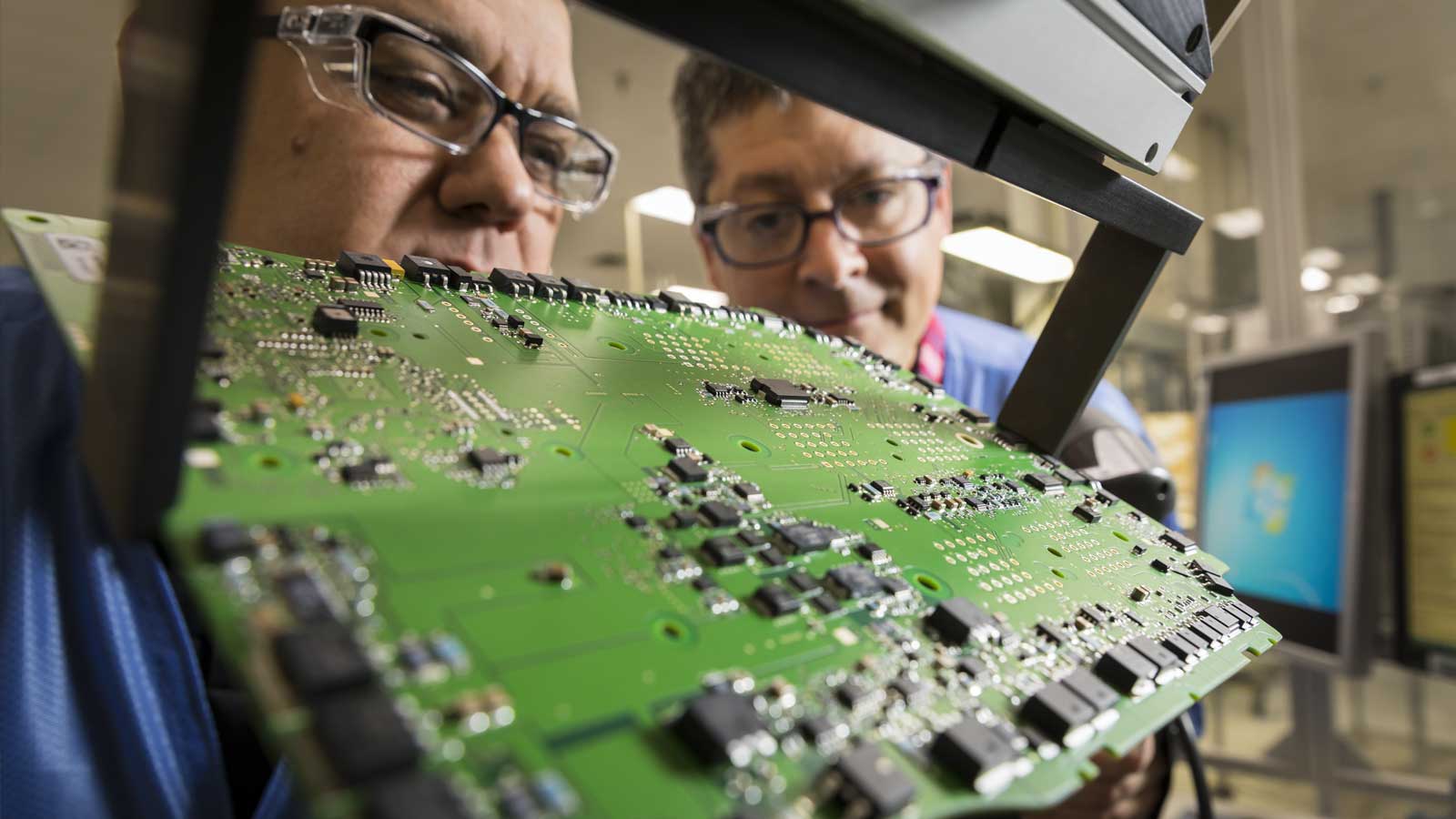 Two men working on a microprocessor