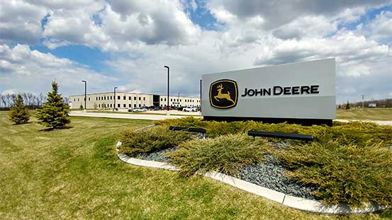 A John Deere sign in front of a building