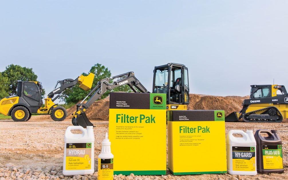 John Deere filter pak displayed with multiple different construction machines in background