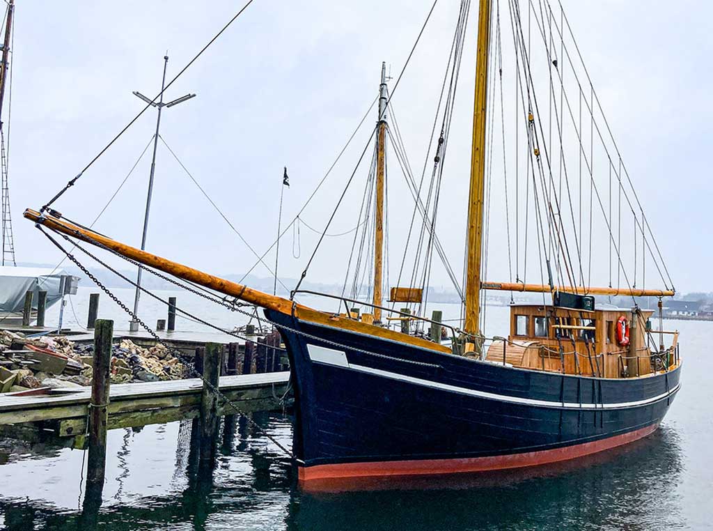 Petersen Tegl’s wooden sailing ship docked in the harbor
