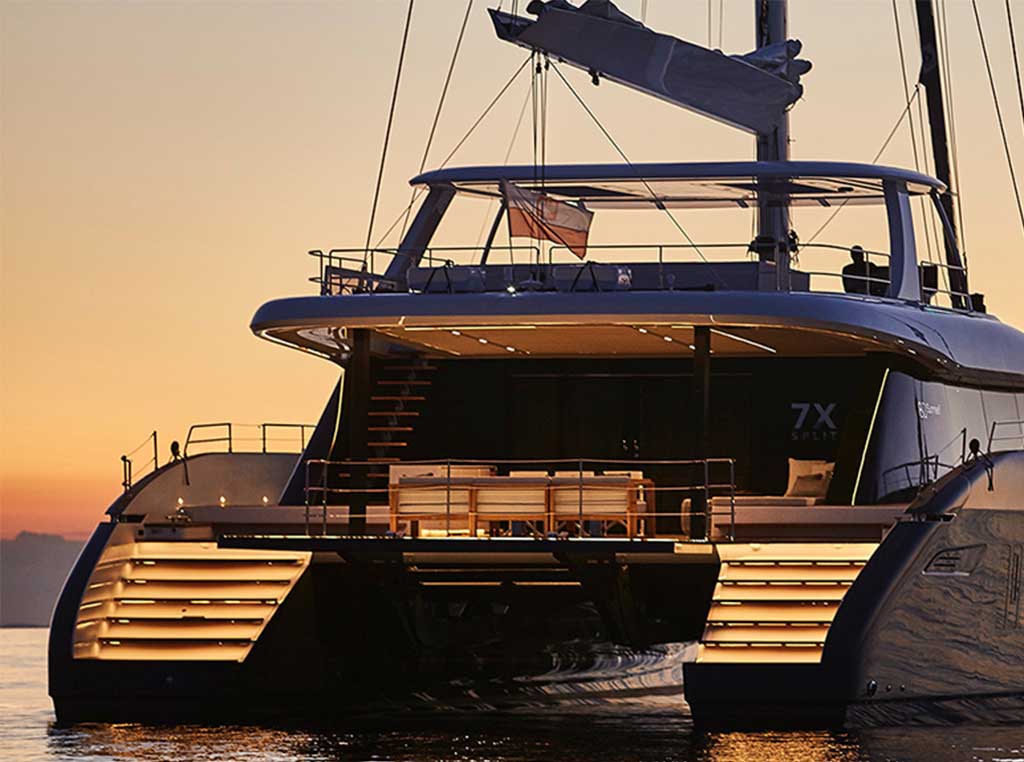 Stern view of Sunreef Superyacht on water at dusk.